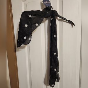 Black scarf with white polka dots.